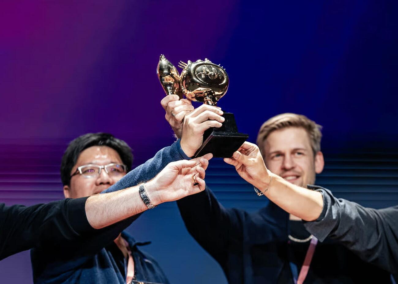 Two Shippies winners holding their trophy aloft on stage